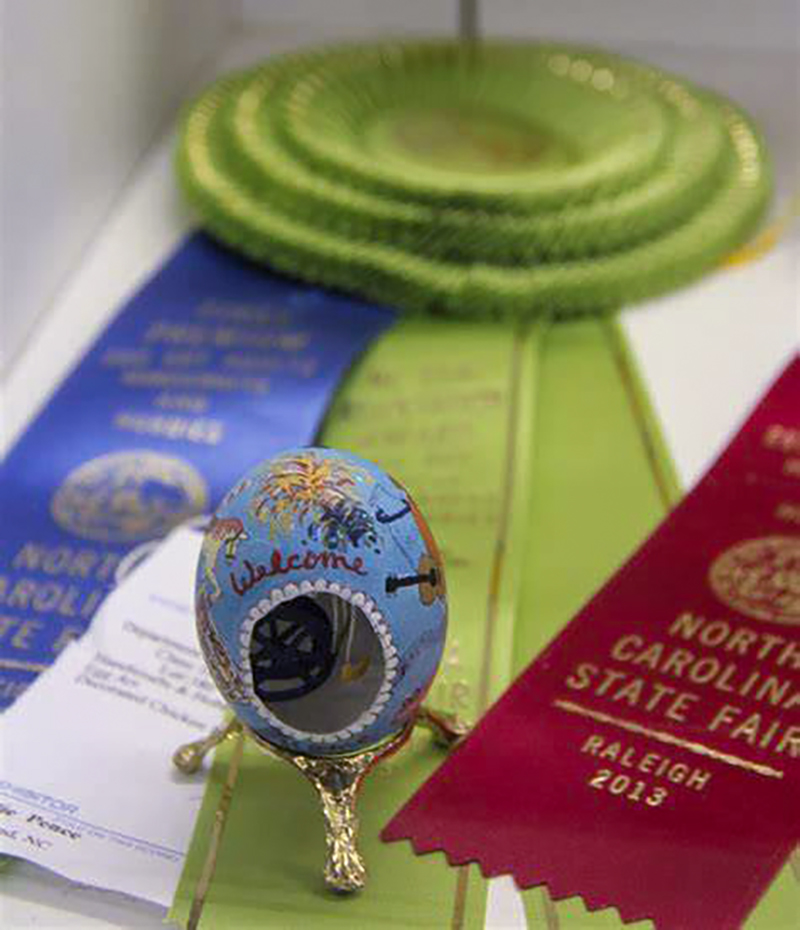 Egg that has blue paint and detailed design on it. Submitted to the state fair.